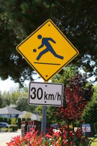 Playground Zone sign (Advisory) with regulatory sign attached for posted 30 km/h speed limit (photo by WestCoastDriverTraining.com)