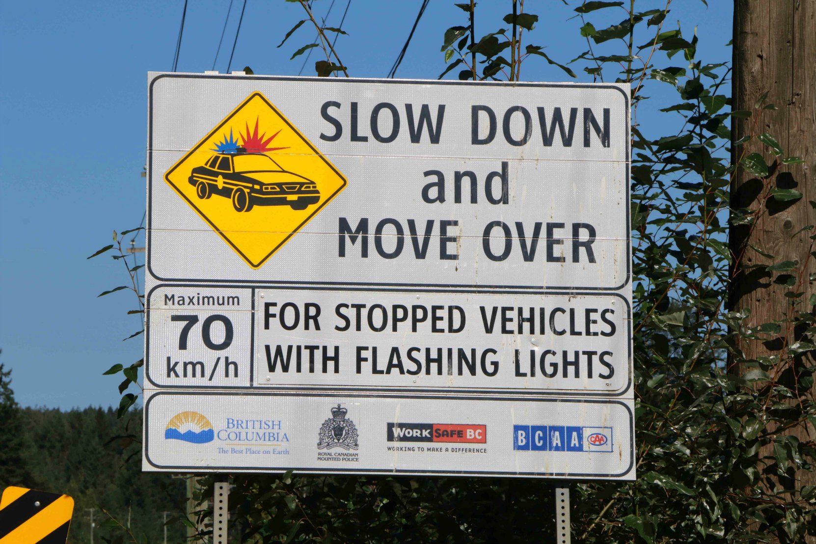 Sign on the Trans-Canada Highway on Vancouver Island stating the British Columbia laws for driving around emergency vehicles on B.C. highways. (photo by West Coast Driver Training & Education)