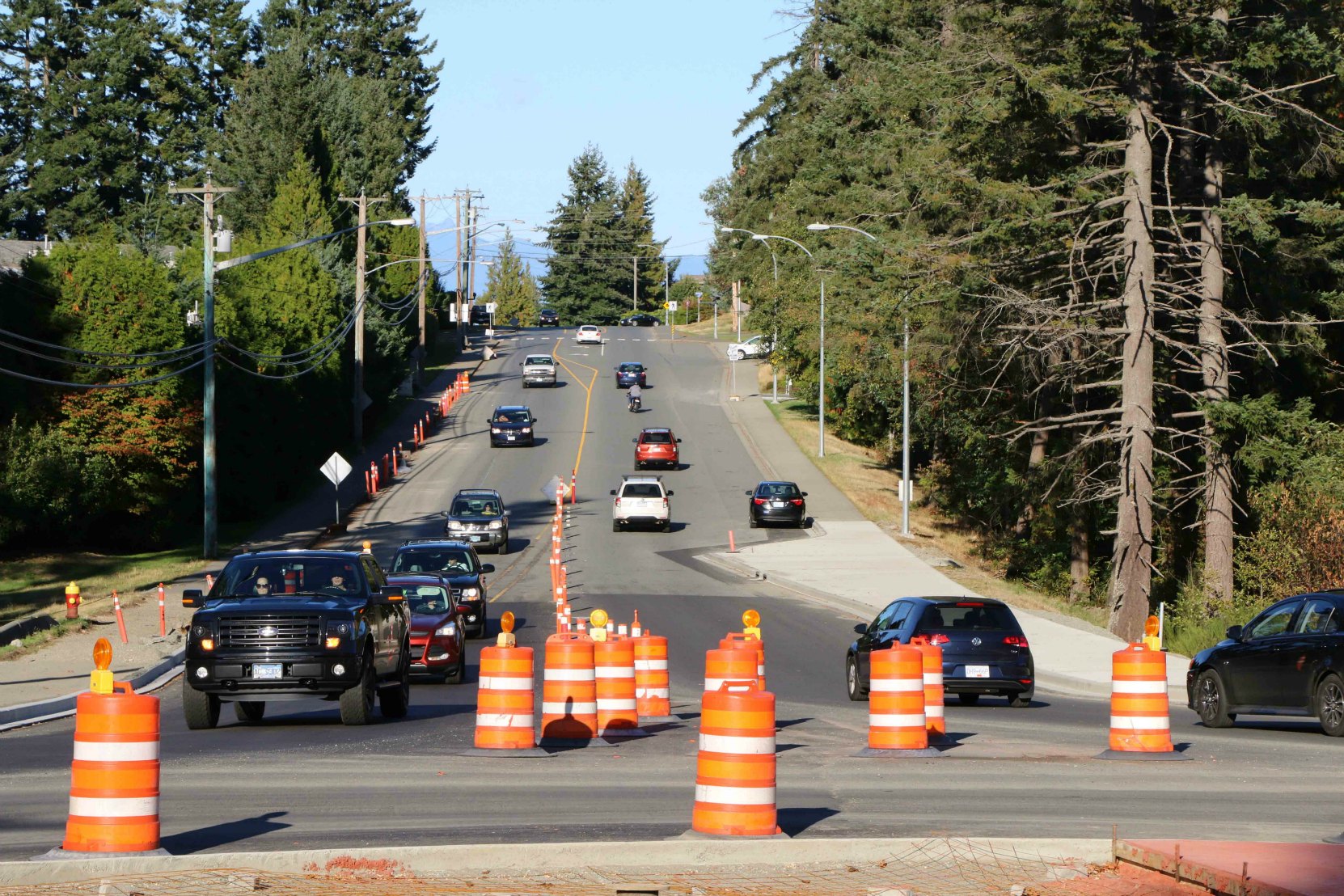 A typical roadway construction zone in British Columbia marked with Orange and Black signs, pylons and markers (photo by WestCoastDriverTraining.com)