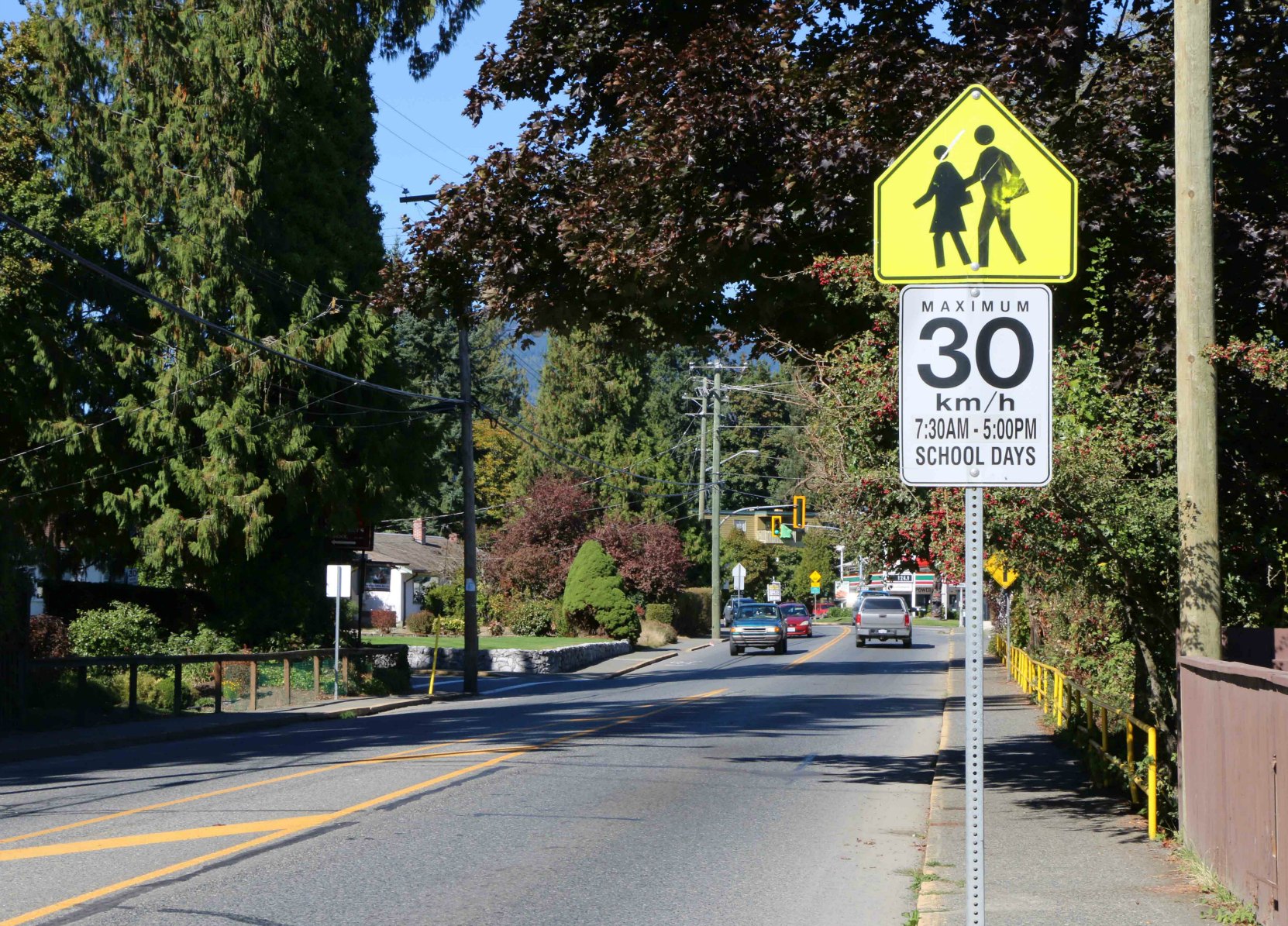 School Zone sign (Advisory) with regulatory sign attached for posted 30 km/h speed limit. Note that this sign contains hours the School Zones is in effect, in this case 7:30 a.m. to 5 p.m. on School Days (photo by WestCoastDriverTraining.com)