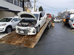 Our 2020 Prius Prime being towed after being hit hit by the white VW being towed (right). The blue SUV on the deck of the tow truck on the right was the first vehicle hit by the white VW being towed by the tow truck on the right of the photo. (photo: West Coast Driver Training)