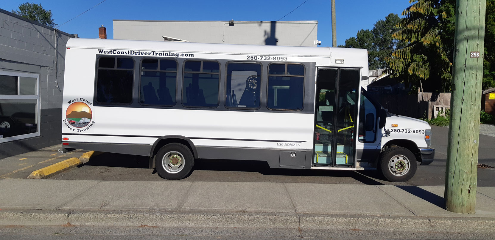 Our Ford E450 20 seat bus at Mark's Instant Sign Shop awaiting application of its final signage [Photo: West Coast Driver Training]