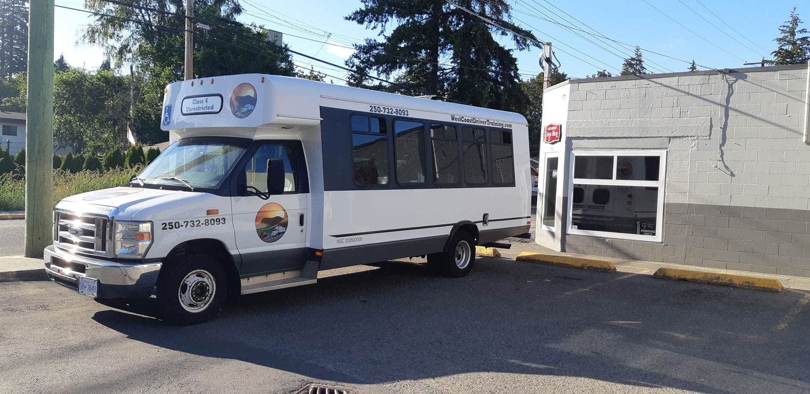 Our Ford E450 20 seat bus at Mark's Instant Sign Shop awaiting application of its final signage [Photo: West Coast Driver Training]