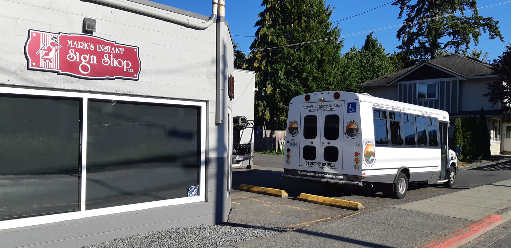 Our Ford E450 20 seat bus at Mark's Instant Sign Shop awaiting application of its final signage [Photo: West Coast Driver Training]