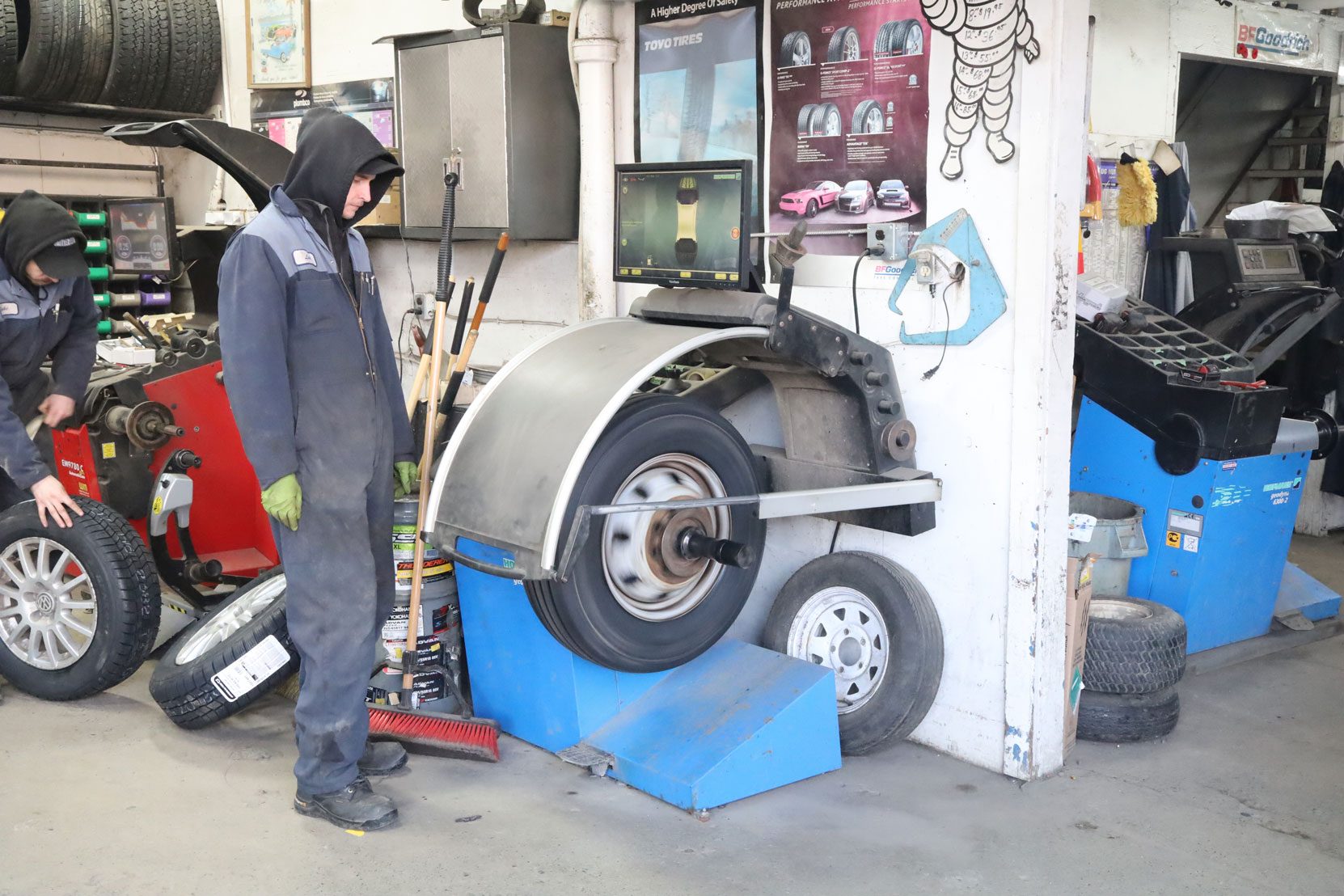 Wheel balancing before the new steering axle tires installed on our Ford E450 bus at Joe's Tire Hospital, February 2023 [photo: West Coast Driver Training]