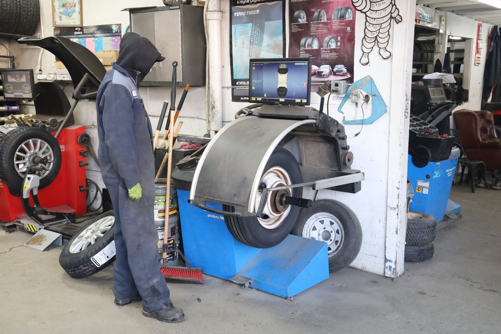 Wheel balancing before the new steering axle tires installed on our Ford E450 bus at Joe's Tire Hospital, February 2023 [photo: West Coast Driver Training]