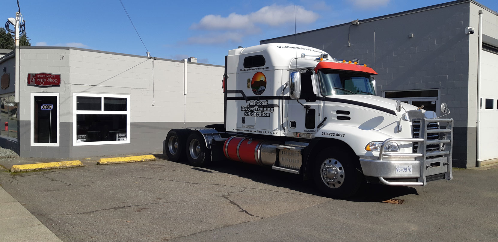 Our 2016 Mack Pinnacle at Mark's Instant Sign Shop after having our corporate decals applied, February 2024 [photo: West Coast Driver Training]