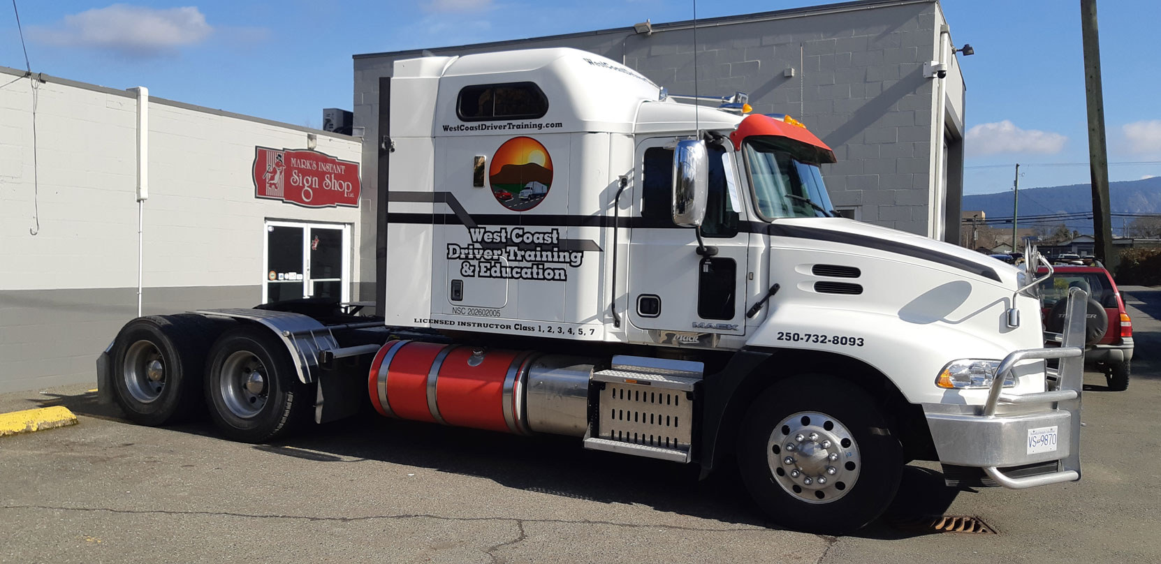 Our 2016 Mack Pinnacle at Mark's Instant Sign Shop after having our corporate decals applied, February 2024 [photo: West Coast Driver Training]